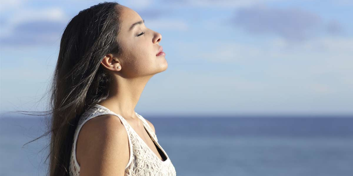 Person sitting in quiet reflection during sunrise, symbolizing spiritual growth and a shift in perspective
